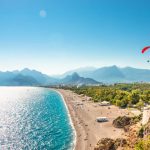 Panoramic bird view of Antalya and Mediterranean seacoast and beach with a paraglider, Antalya, Turkey, Autumn