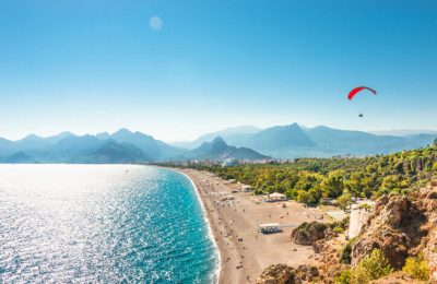 Panoramic bird view of Antalya and Mediterranean seacoast and beach with a paraglider, Antalya, Turkey, Autumn