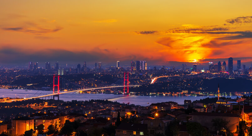 Bright sunset and the Boshporus Bridge in Istanbul, view from the Asian side, Turkey.